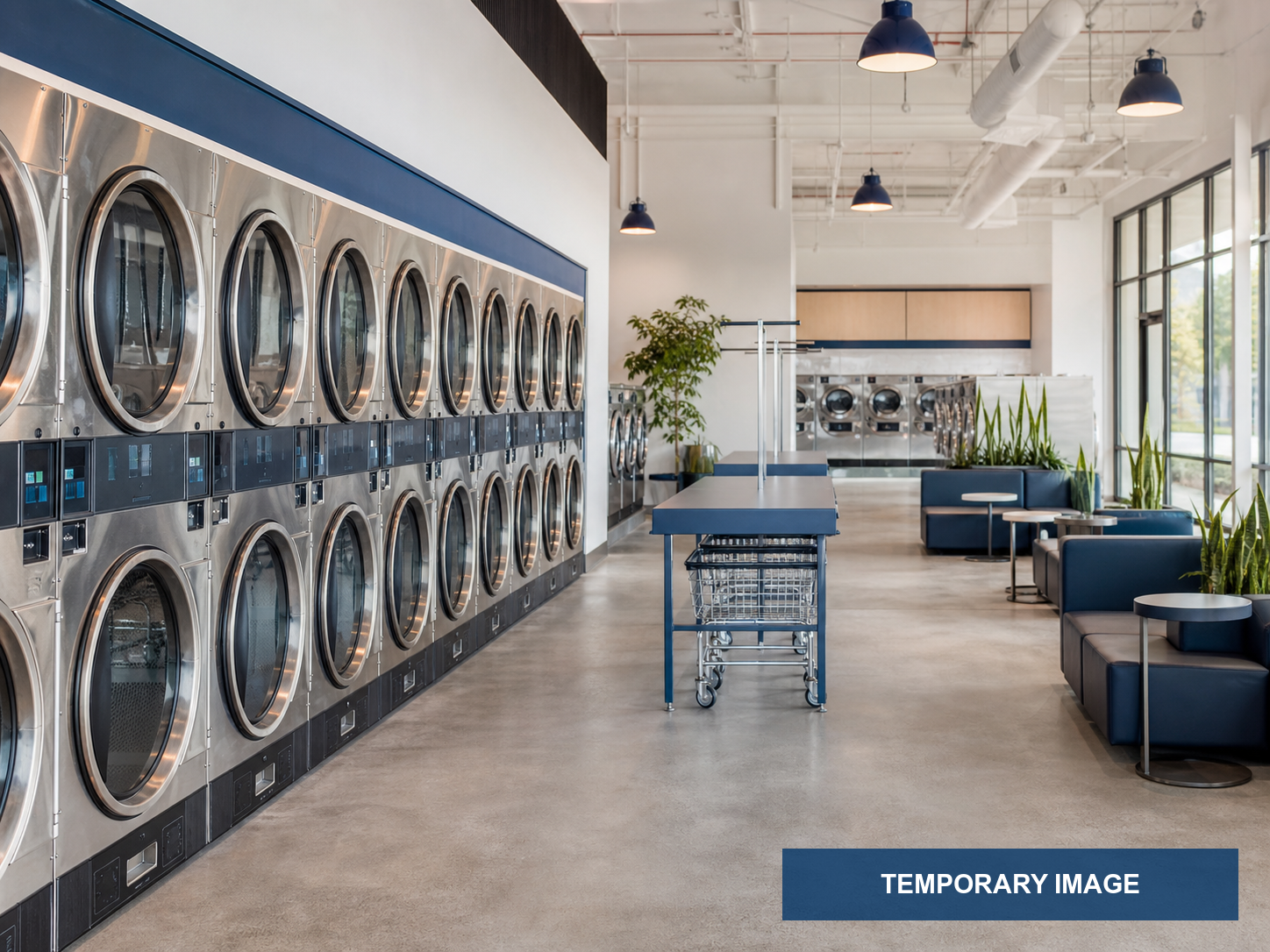 Modern large-capacity stainless washers in a clean WashFoundry laundry room